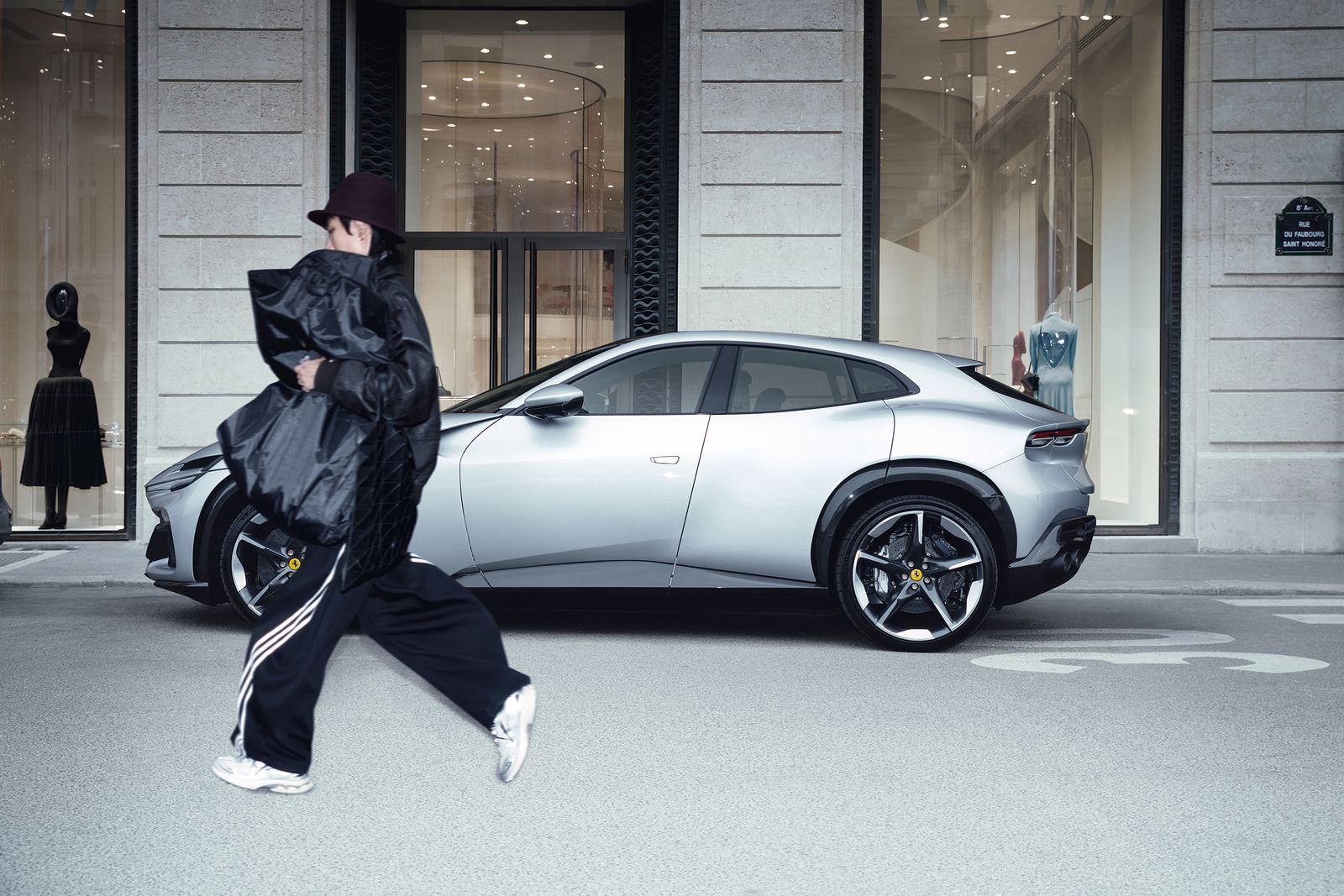 Ferrari Purosangue with a model on a Paris street