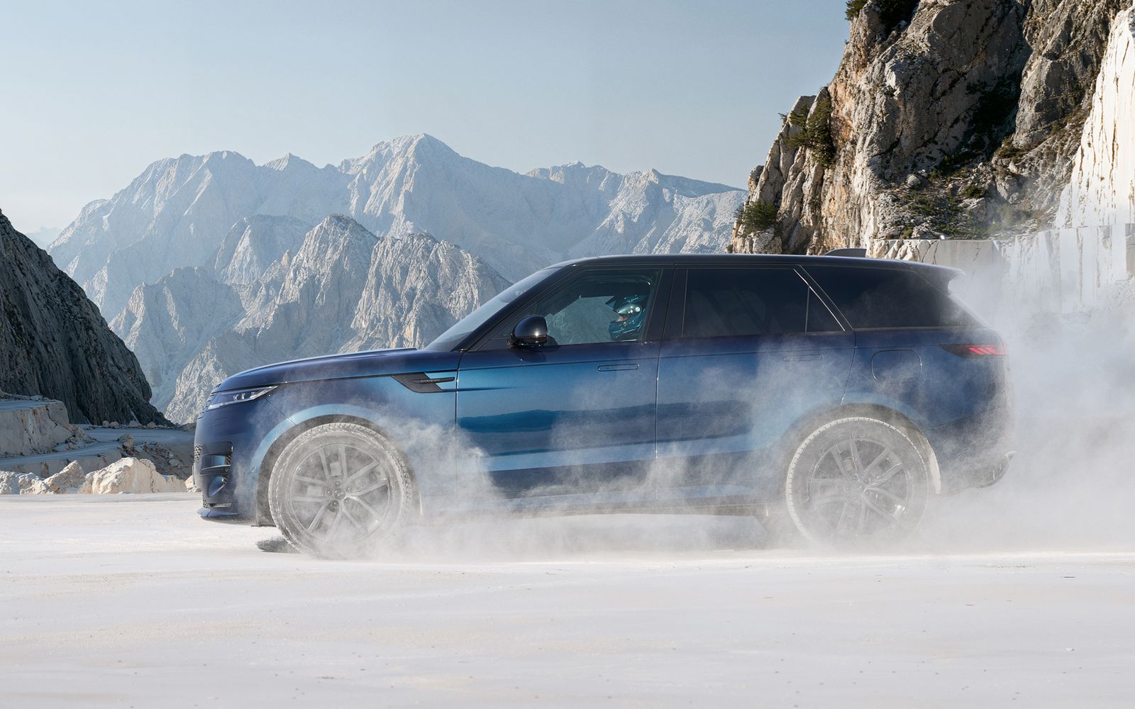 Range Rover Sport driving through powder in a mountain quarry